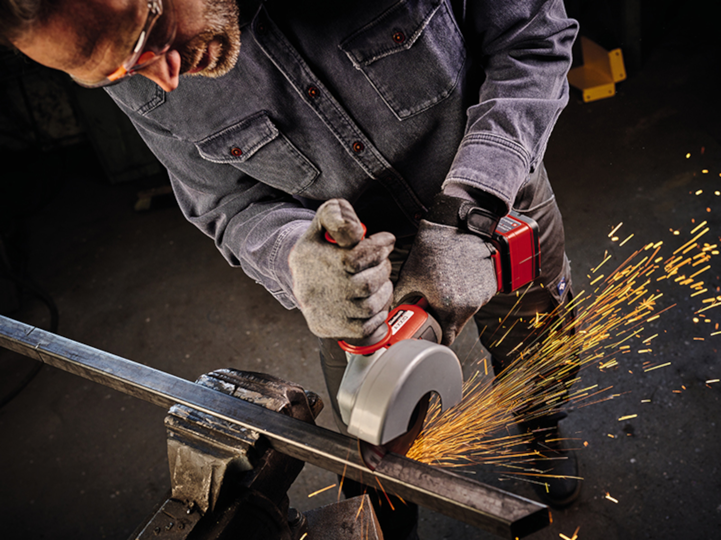 Picture of a man working with an angle grinder.