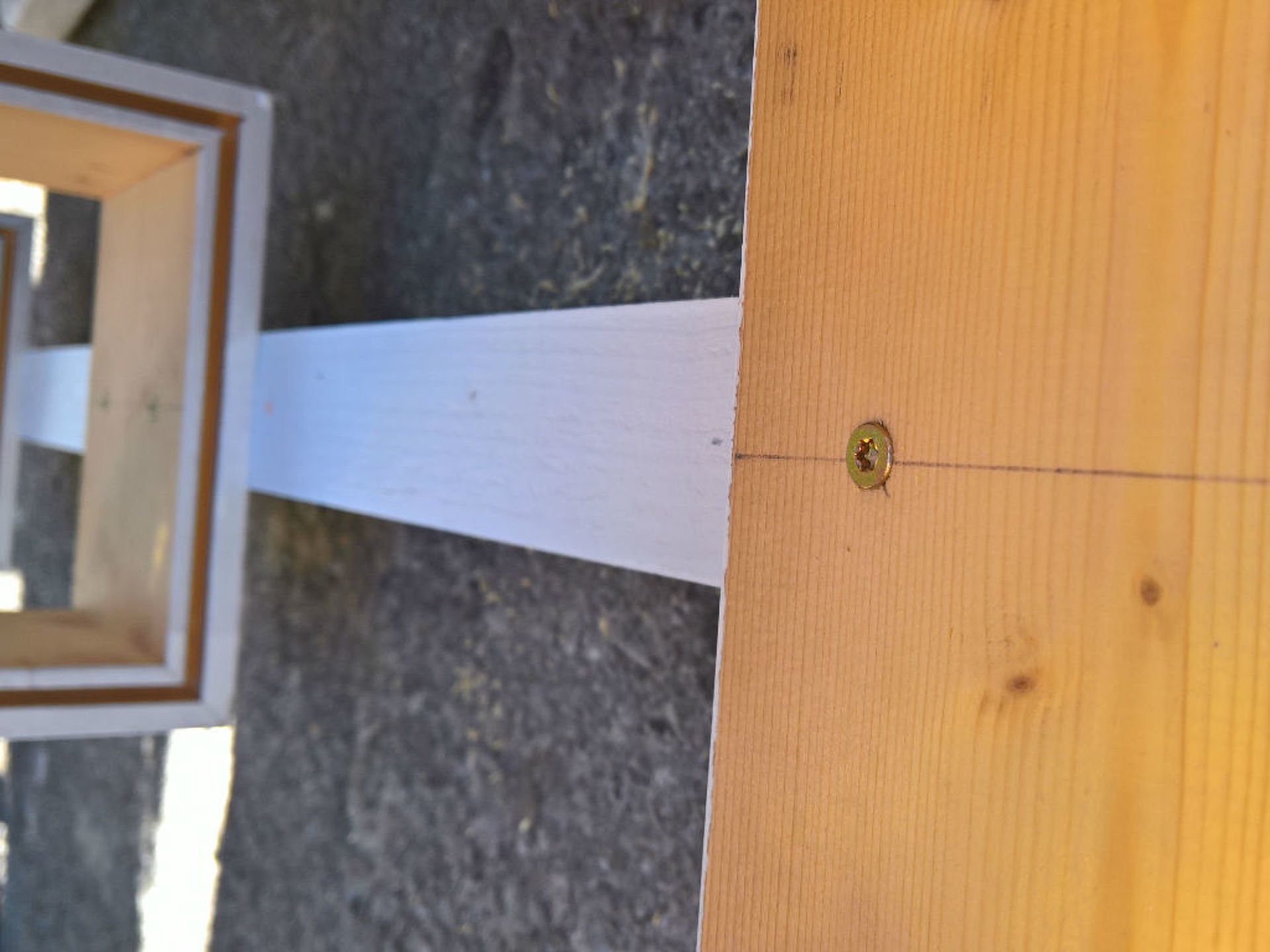 The center of a wooden board was marked with a drawn line.