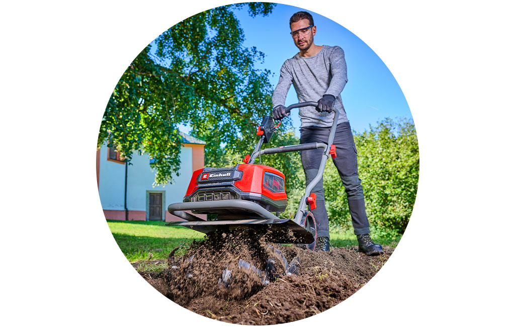 a man works with the Einhell cordless tiller