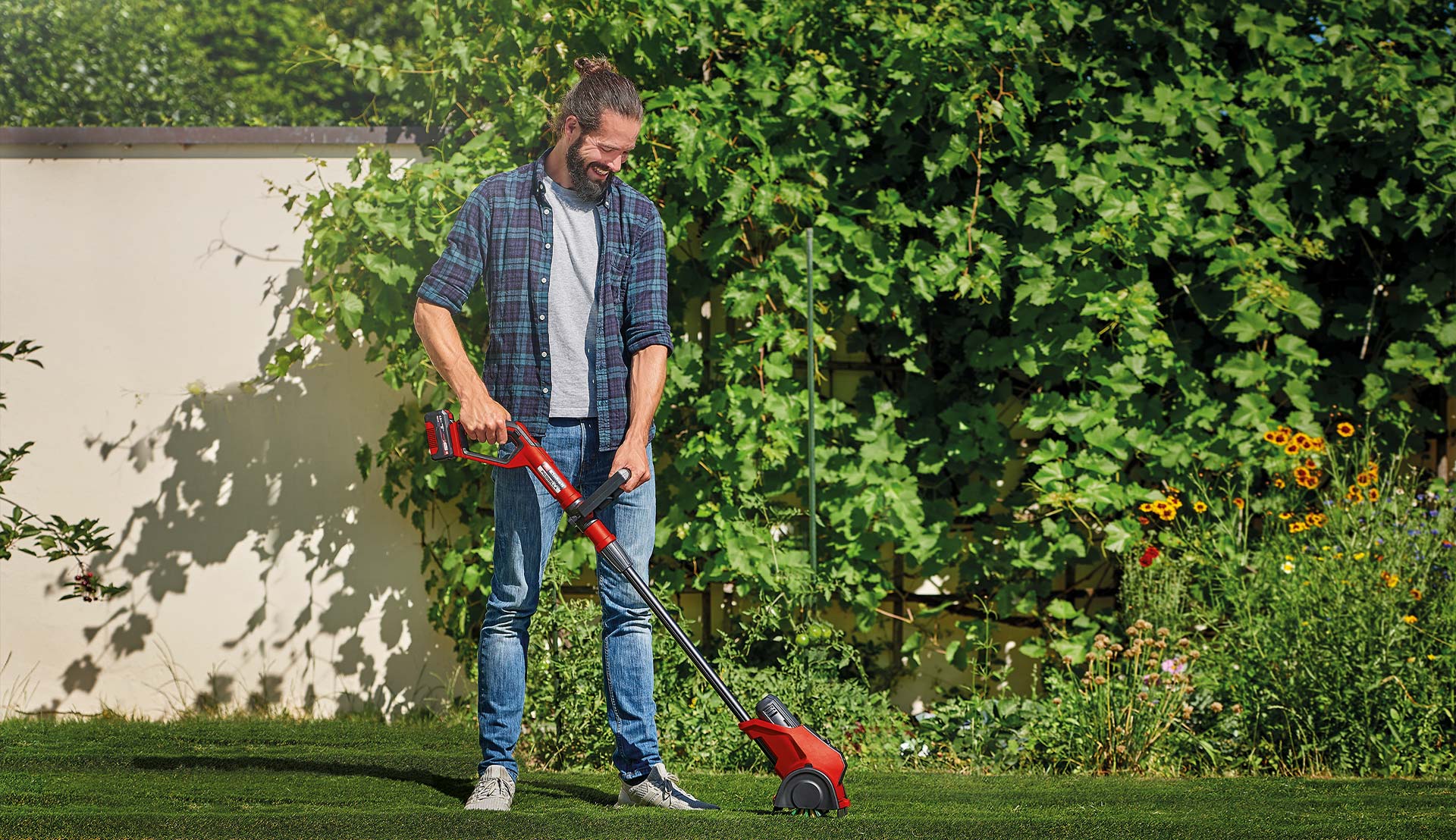 a man works in the garden with the surface brush