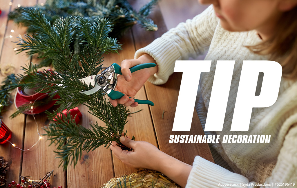 A person uses pruning shears to cut a pine branch for sustainable decoration, with the title "Tip: Sustainable Decor".