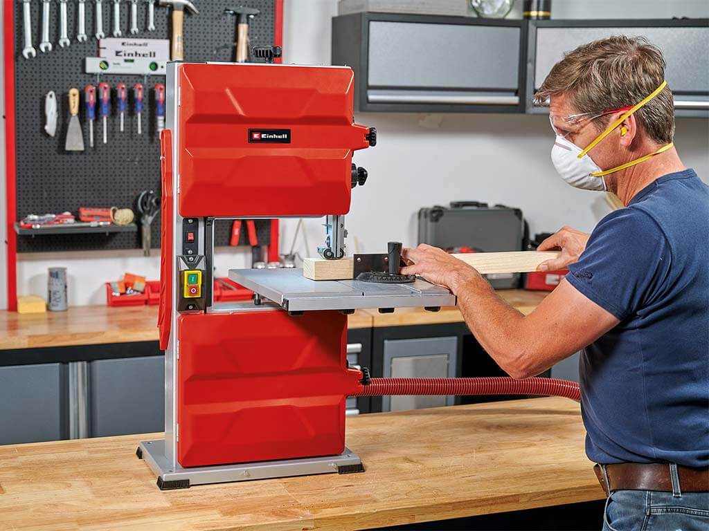 A man cuts wood with a jigsaw