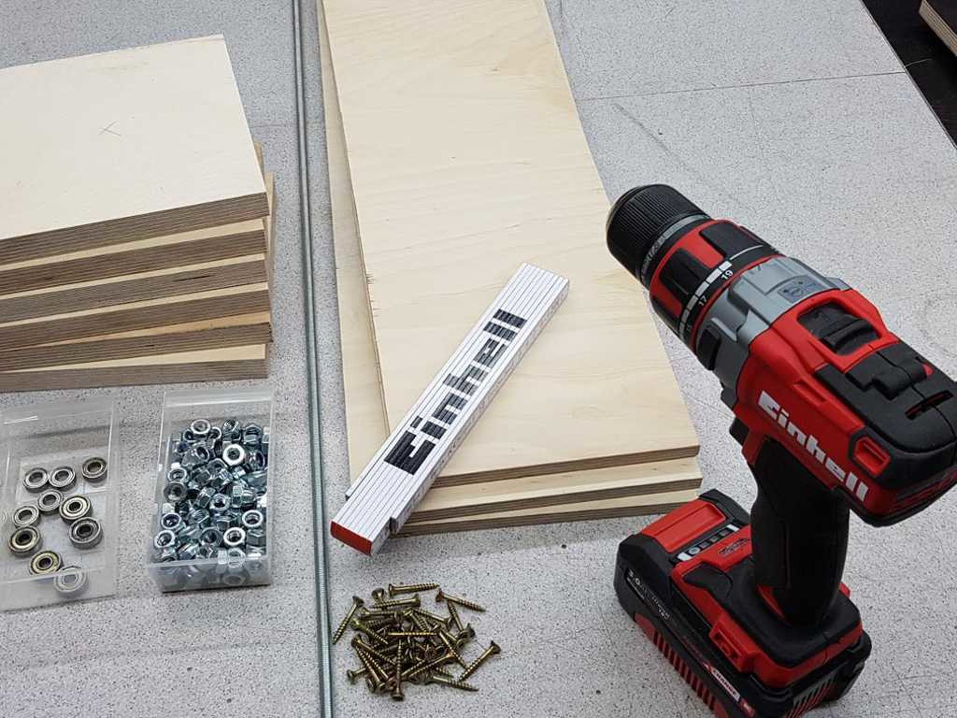 wood boards with meter stick screws and an electric screwdriver