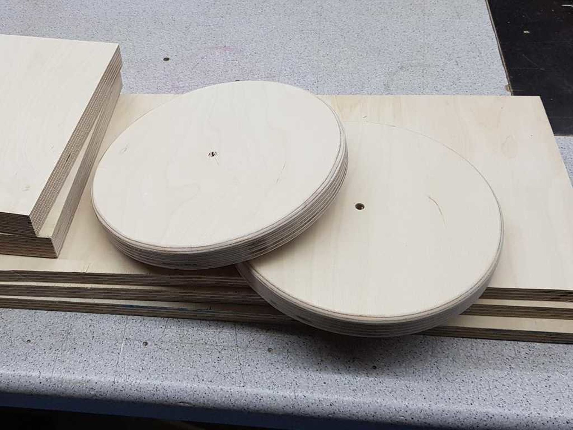 wooden boards and two wooden discs with a hole in the middle