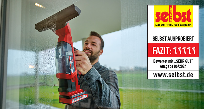 A man cleans a window with the Einhell cordless window cleaner BRILLIANTO, rated "Very Good" by "selbst ist der Mann" in issue 06/2024.