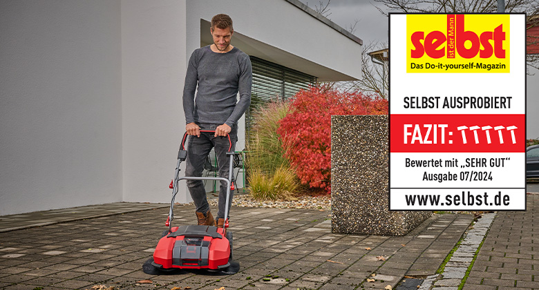 A man uses an Einhell cordless push sweeper outdoors, rated "Very Good" by "selbst ist der Mann" in issue 07/2024.