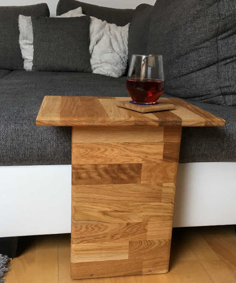 wooden couch table with a glass on it