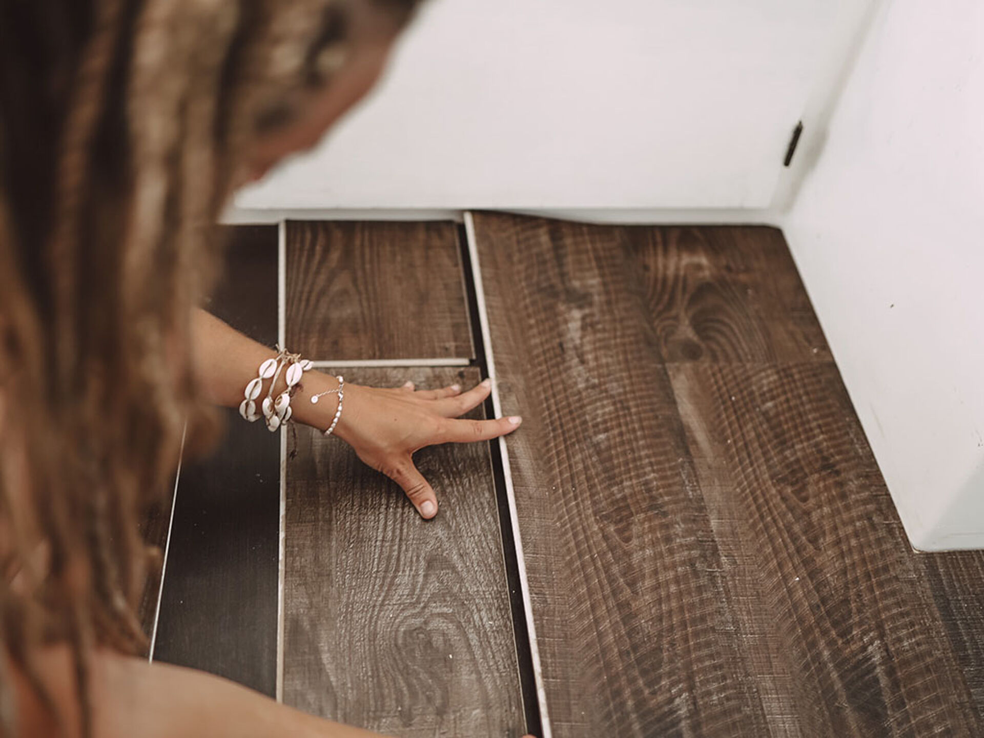 a woman lays a floor slab