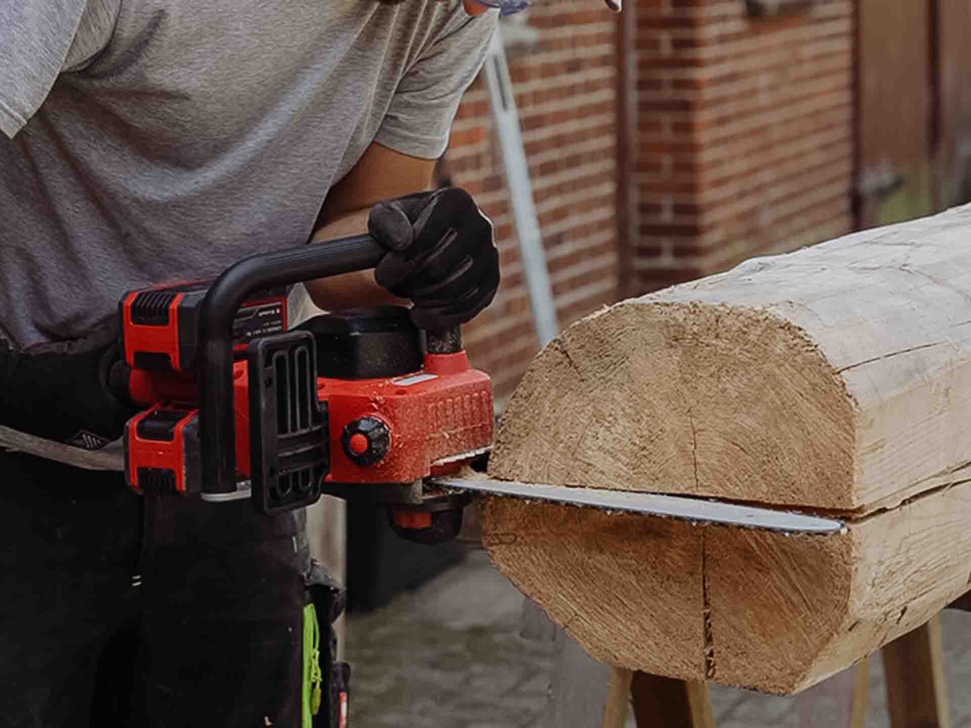 a tree trunk is cut in half with a chainsaw