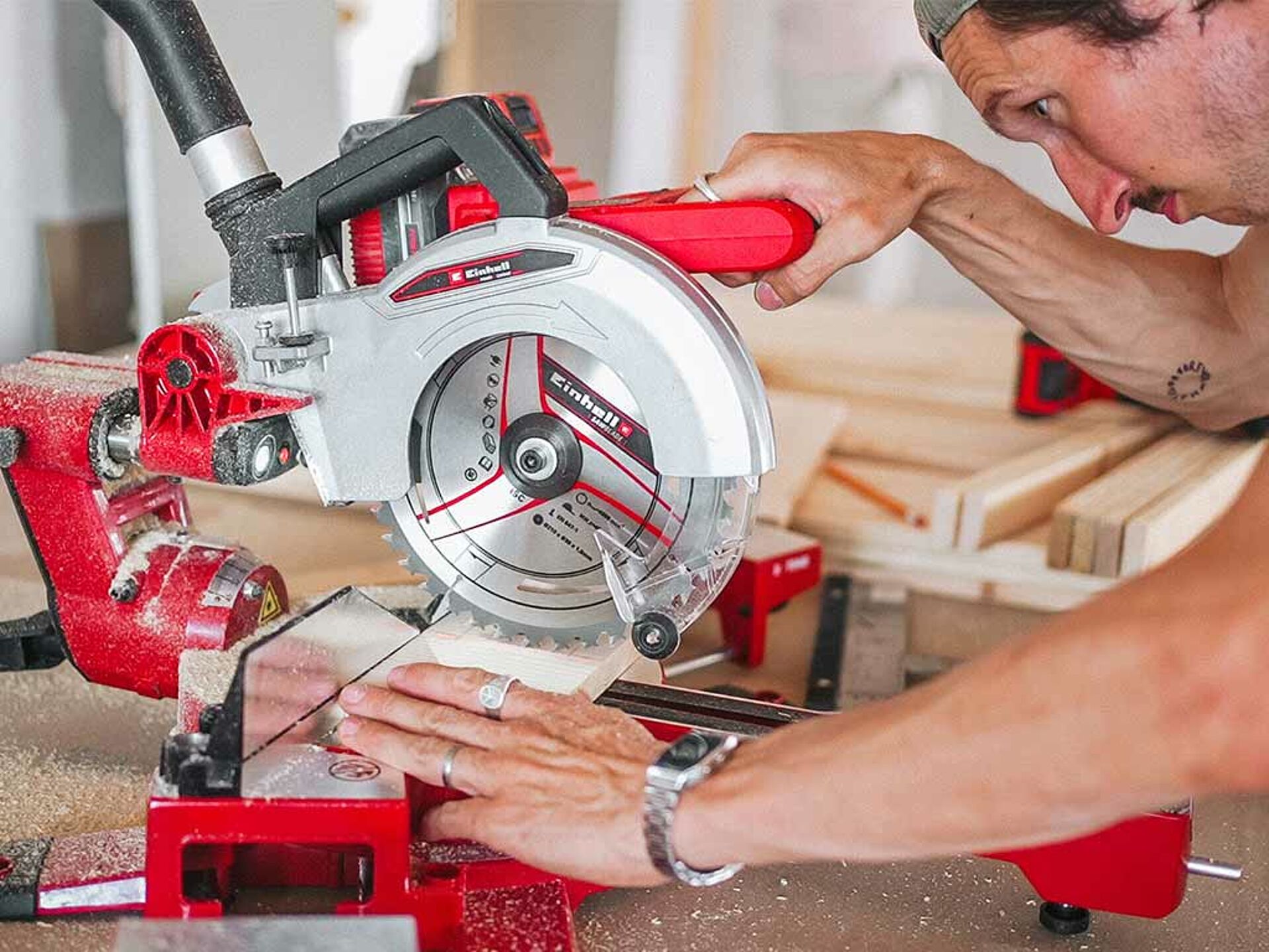 A man cuts wood with a circular saw