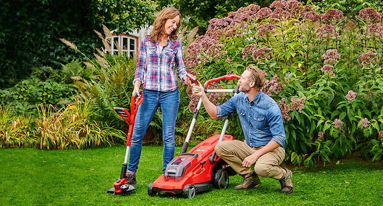 woman and man with a trimmer and a lawn mower